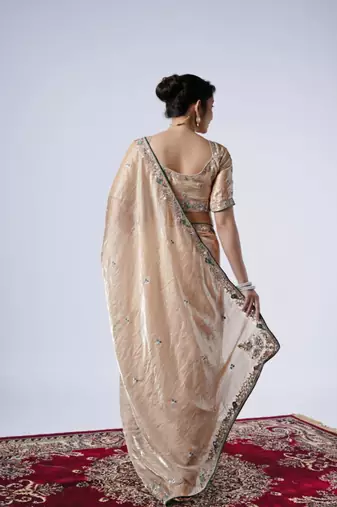 Celebrity inspired cream embroiderd border satin saree with unstitched blouse