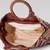  lines & loops tan jacquard chevron handheld bag
