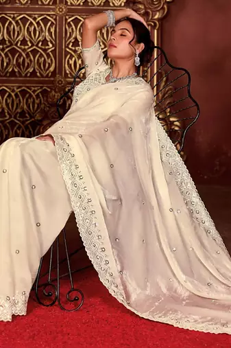 Celebrity inspired cream diamond sequin jaal embroidered border mono nylon fabric saree with unstitched blouse