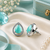 Rhodium finish mint glow teardrop studs