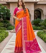 Orange color pochampally silk blend ikkat pattern zari woven border sarees