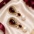 Gold tone black enamel wine statement earrings