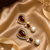 Gold tone black enamel wine statement earrings