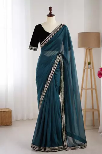 Teal net embroidered saree with sequins work
