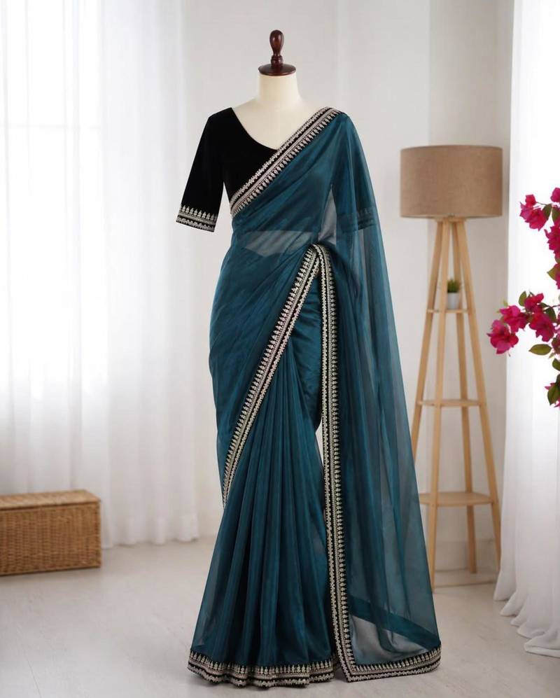 Teal net embroidered saree with sequins work