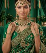 Green 2-layer bridal jewelry set with earrings, maang tikka, pasha, nath & panja | gold plated