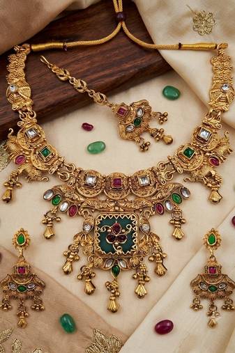 Women gold-toned & green temple antique jewellery set with maang tikka