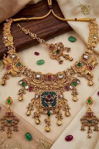Women gold-toned & green temple antique jewellery set with maang tikka