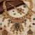 Women gold-toned & green temple antique jewellery set with maang tikka