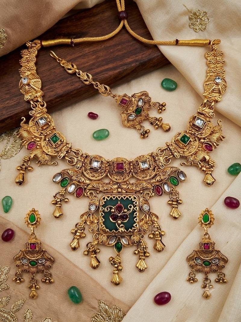 Women gold-toned & green temple antique jewellery set with maang tikka