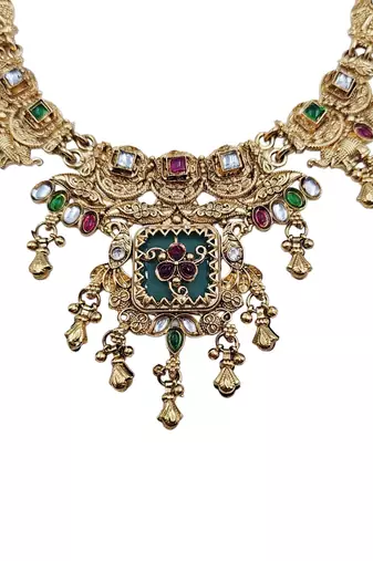 Women gold-toned & green temple antique jewellery set with maang tikka