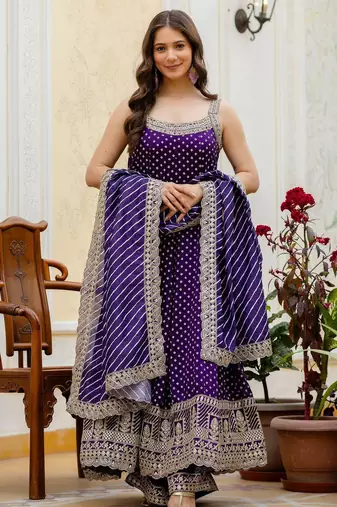 Designer halter neck bandhej kurti set with flared palazzo & leheriya dupatta for festive wear
