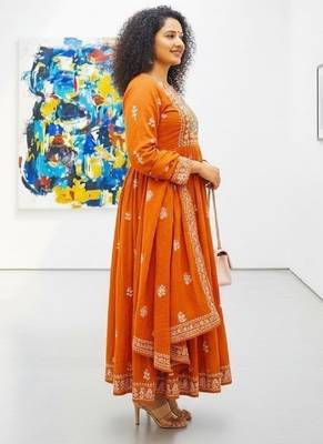 Orange cotton floral printed flared kurta set with dupatta 2
