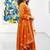 Orange cotton floral printed flared kurta set with dupatta
