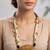 Gold plated white knotted nest pendant necklace