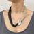 Beige black knot loop necklace
