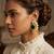 Gold plated emerald green stone coiled wave earrings