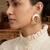 Gold plated grey circular disc earrings
