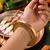 Gold plated metallic ribbed bangle