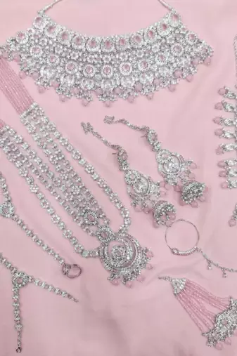 Baby pink 2-layer bridal jewelry set with earrings, maang tikka, pasha, nath & panja | rhodium plated