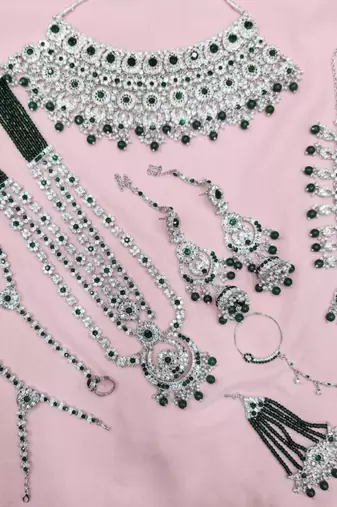 Green 2-layer bridal jewelry set with earrings, maang tikka, pasha, nath & panja | rhodium plated