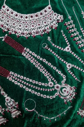 Maroon 2-layer bridal jewelry set with earrings, maang tikka, pasha, nath & panja | rhodium plated