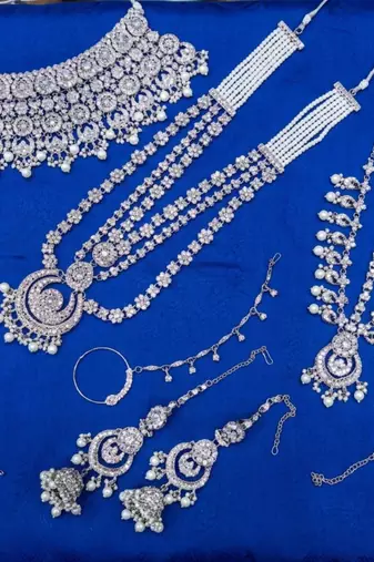 White 2-layer bridal jewelry set with earrings, maang tikka, pasha, nath & panja | rhodium plated