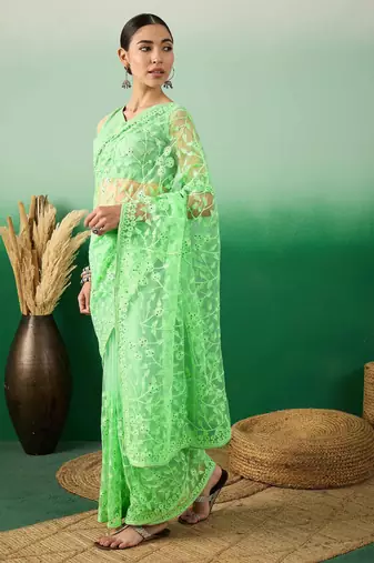 Pastel green work net saree with floral design
