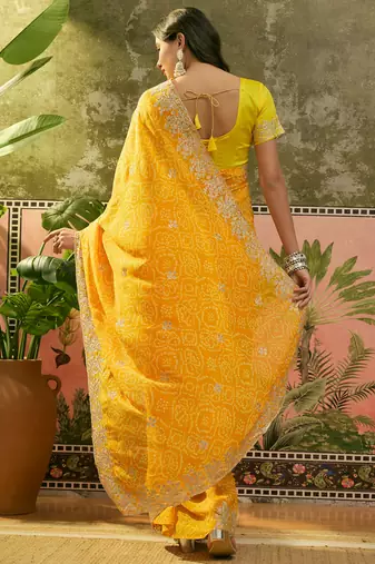 Yellow bandhani printed saree with embroidered border