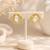 Baroque pearl stud earrings with gold wire wrap design