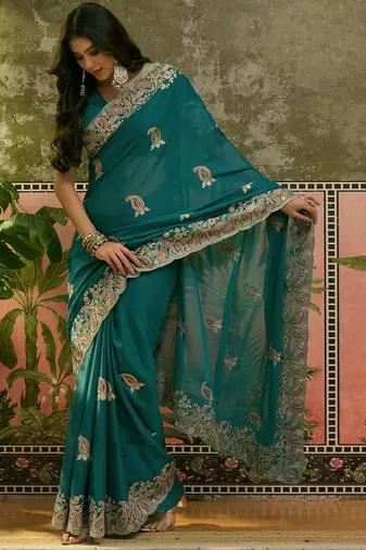 teal blue embroidered saree with paisley motifs