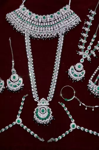 Green 2-layer bridal jewelry set with earrings, maang tikka, pasha, nath & panja | rhodium plated