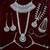Green 2-layer bridal jewelry set with earrings, maang tikka, pasha, nath & panja | rhodium plated