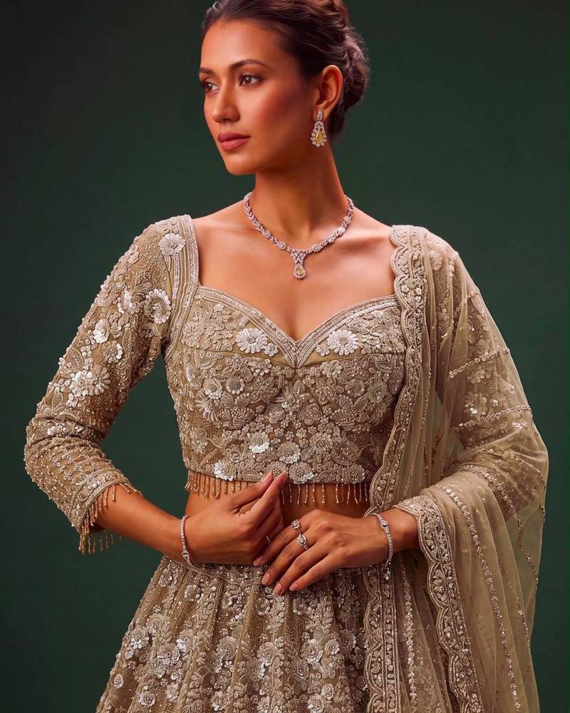 Beige Net Heavily Embroidered Royal Bridal Reception Lehenga Choli Set