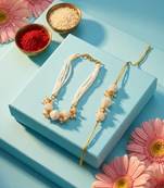 set of 2 gold toned & white pearls bhaiya bhabhi rakhi with roli chawal chandan mishri