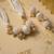 set of 2 gold toned & white pearls bhaiya bhabhi rakhi with roli chawal chandan mishri