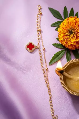 women artrificial stones gold plated rakhi with roli chawal chandan mishri