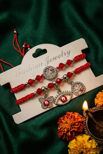 set of 2 red & silver evil eye design bhaiya bhabhi rakhi with roli chawal chandan