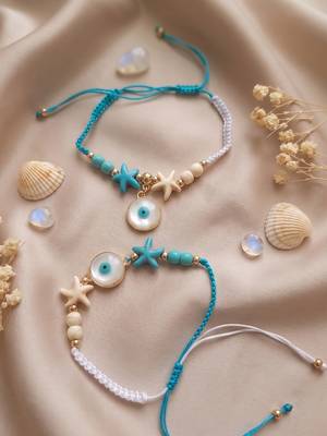 set of 2 blue evil eye & white pearl bhaiya bhabhi rakhi with roli chawal chandan 1