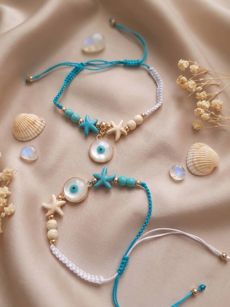 set of 2 blue evil eye & white pearl bhaiya bhabhi rakhi with roli chawal chandan