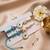 set of 2 blue evil eye & white pearl bhaiya bhabhi rakhi with roli chawal chandan