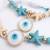 set of 2 blue evil eye & white pearl bhaiya bhabhi rakhi with roli chawal chandan