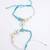 set of 2 blue evil eye & white pearl bhaiya bhabhi rakhi with roli chawal chandan