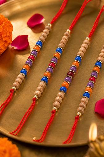 set of 4 multicolor circular beads studded thread rakhi with roli chawal chandan