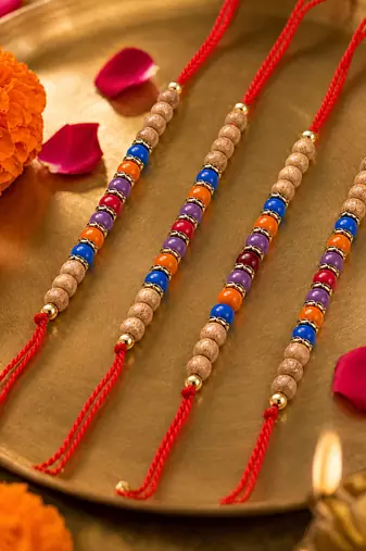 set of 4 multicolor circular beads studded thread rakhi with roli chawal chandan