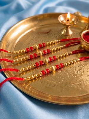 set of 4 artificial beads red thread rakhi with roli chawal chandan mishri 4