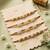 set of 4 white pearls & red thread rakhi with roli chawal chandan mishri