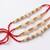set of 4 white pearls & red thread rakhi with roli chawal chandan mishri