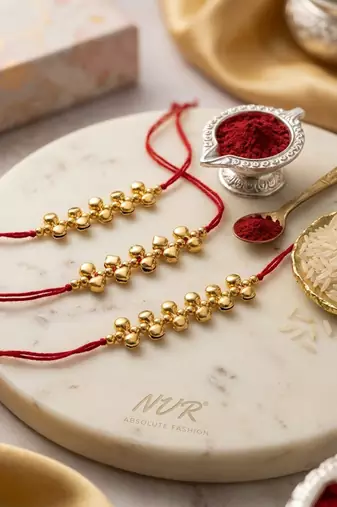 set of 3 gold toned ghungroo & red thread rakhi with roli chawal chandan mishri