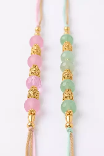set of 2 pink & green artificial beads thread rakhi with roli chawal chandan mishri
